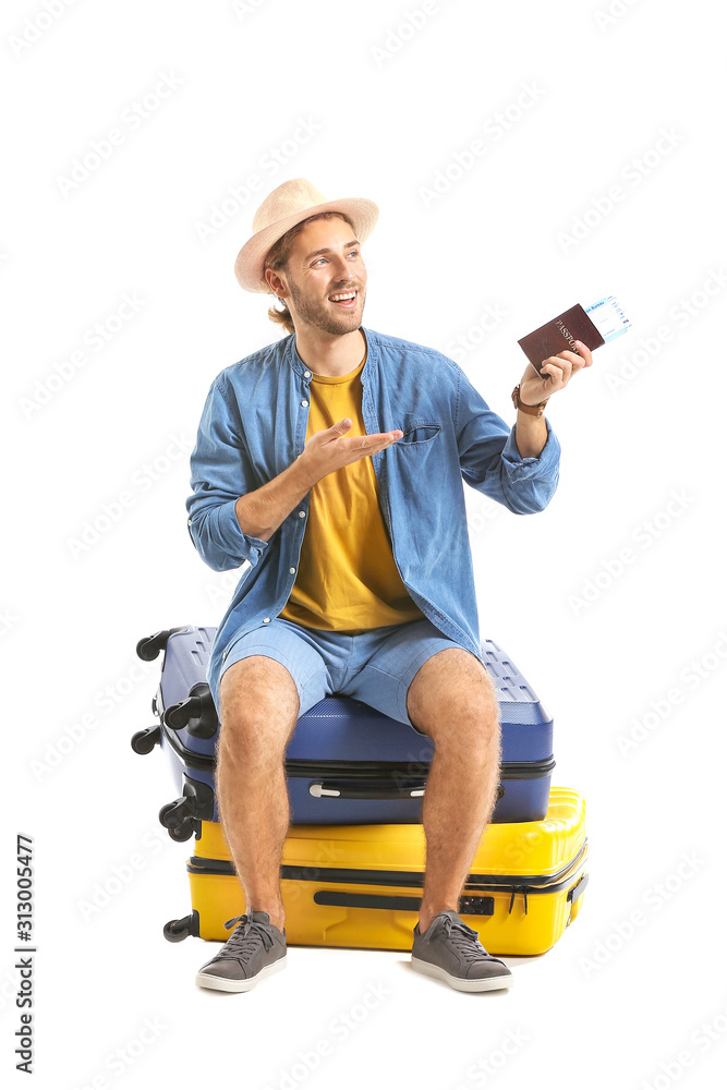 Young tourist with luggage isolated on white