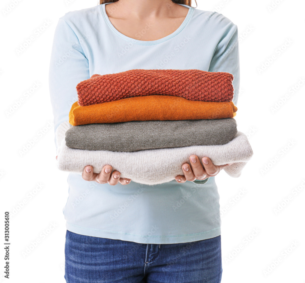 Young woman with clean laundry on white background