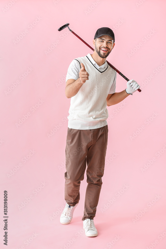 Handsome male golfer on color background