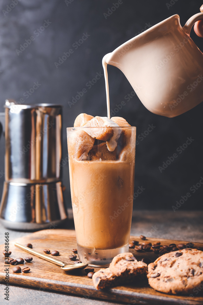 Preparing of iced coffee on dark background