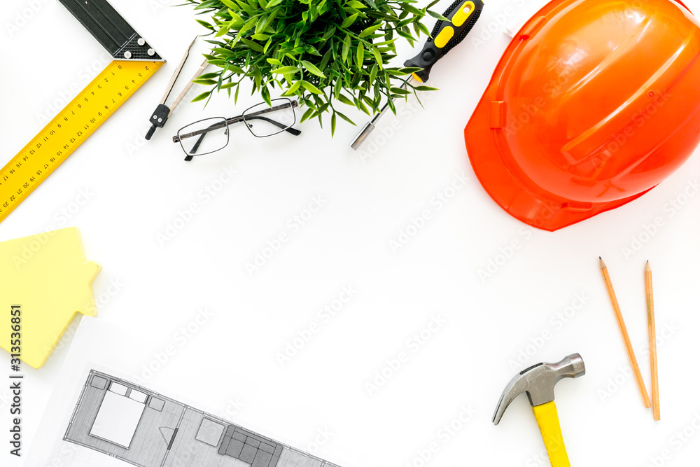 Builder work desk with hard hat, instruments and blueprints on white background top-down frame copy 