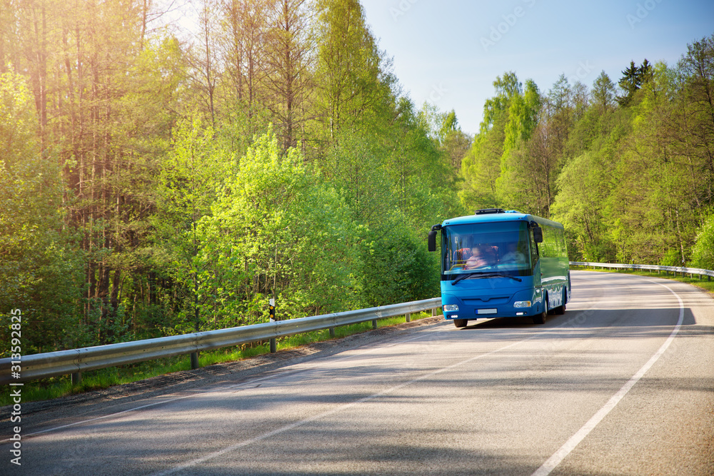 Bus on asphalt road in beautiful spring day