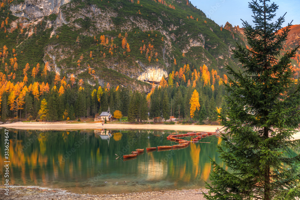 Line of boats on the Lago di Braies lake, Dolomites. Italy