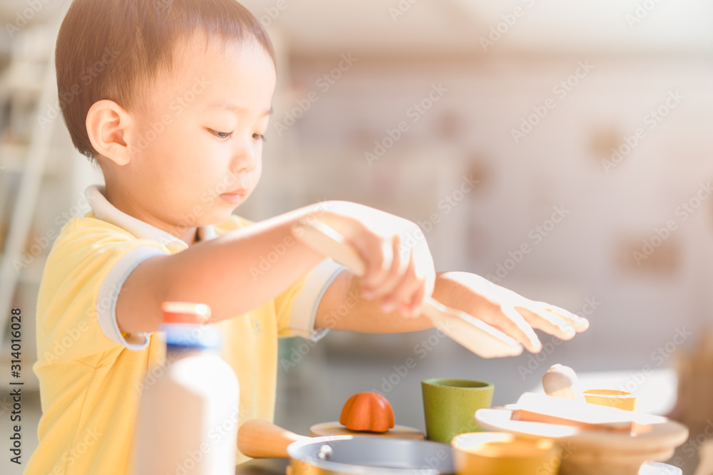 2.9 years old boy.Little child boy playing with lots of wooden toys kitchen ware like a chef.Kid pla