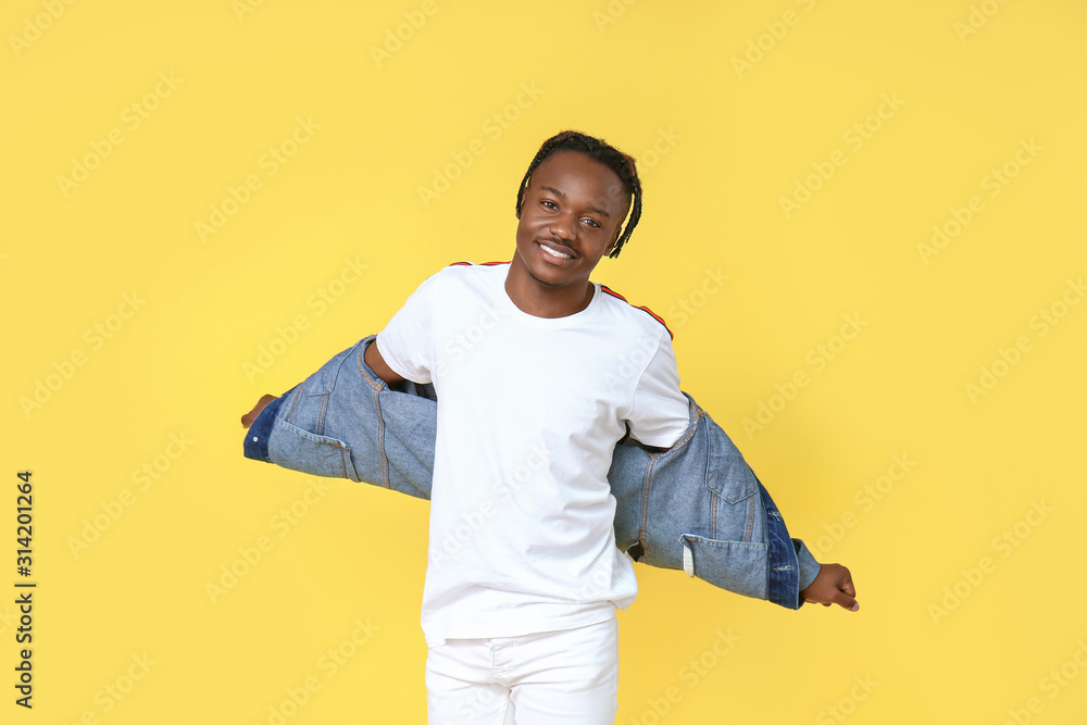 Portrait of stylish African-American man on color background