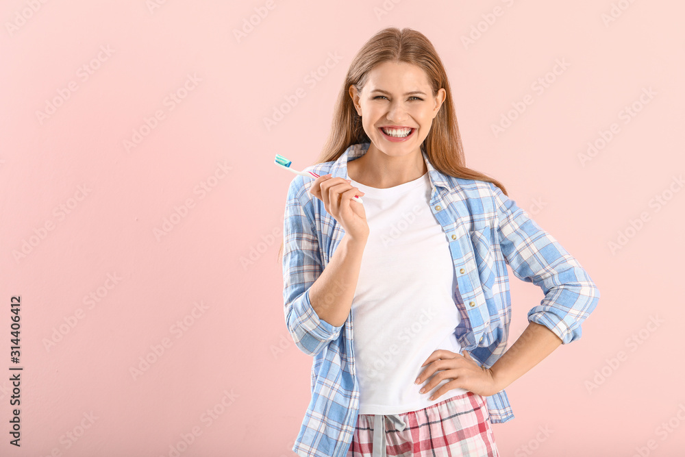 Young woman with toothbrush on color background