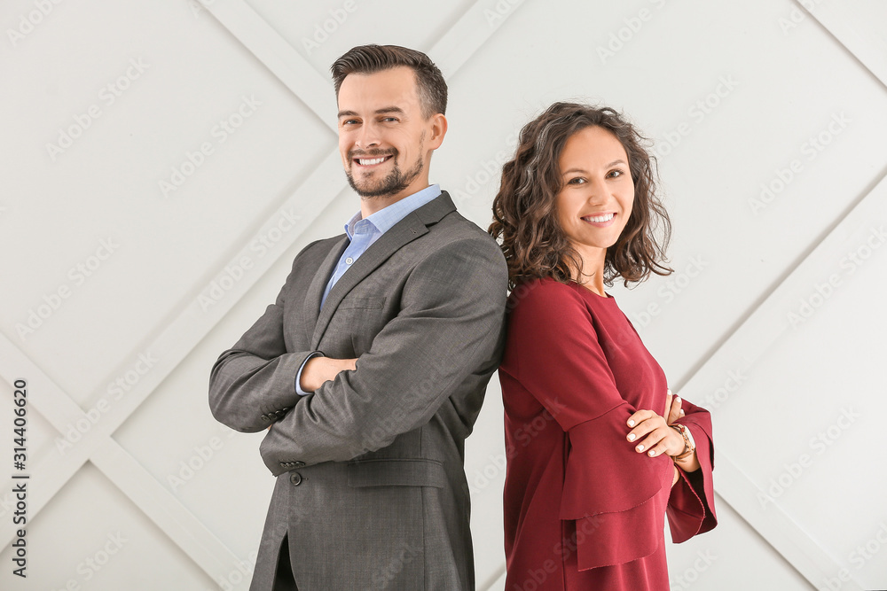 Portrait of young business people on grey background