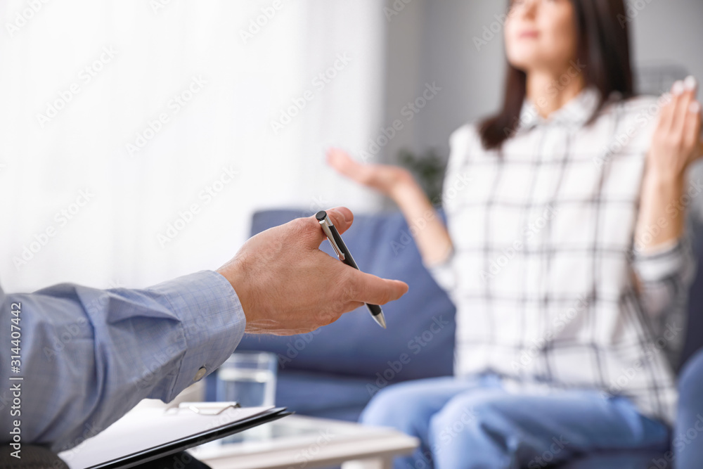 Psychologist working with young woman in office, closeup