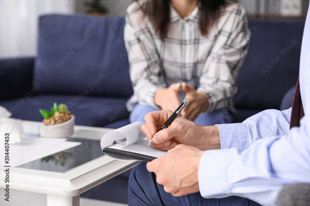 Psychologist working with young woman in office, closeup