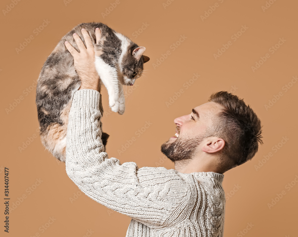 Man with cute cat on color background