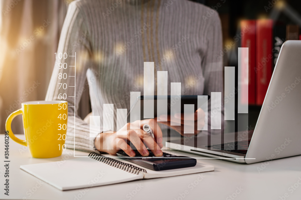 Businessman hands working with finances about cost and calculator and laptop with tablet, smartphone