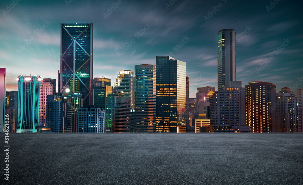 empty asphalt road with beautiful night cityscape scene .