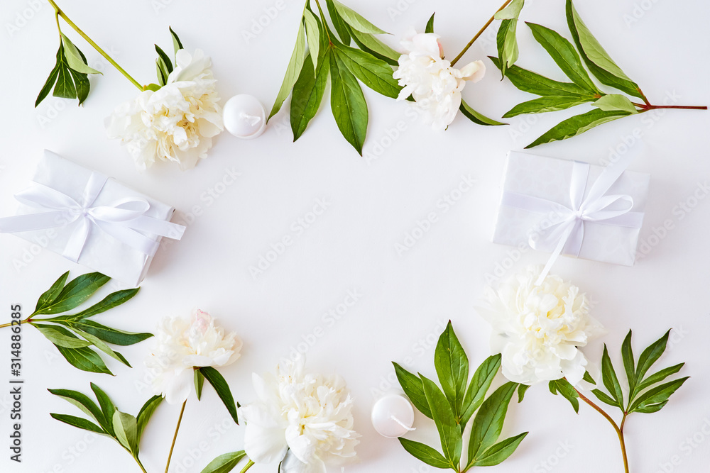 Flat lay composition with white peonies and gift box on a white background