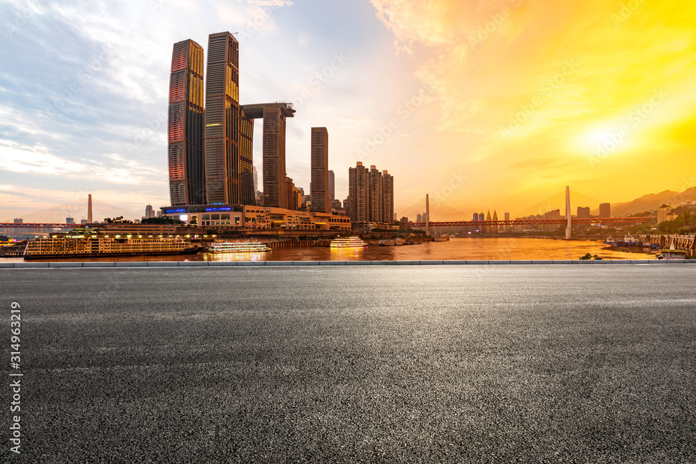 Empty asphalt road and city skyline with buildings in Chongqing at sunset,China.