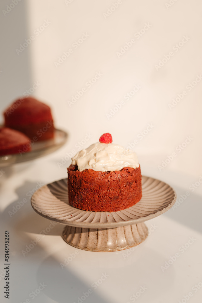 Stand with piece of delicious homemade raspberry cupcake