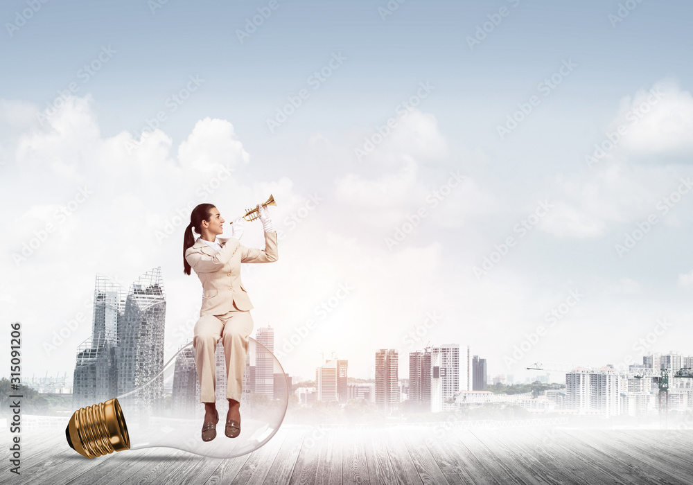 Attractive woman playing trumpet brass