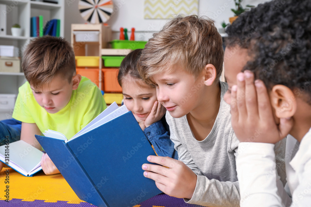 Cute little children reading books indoors