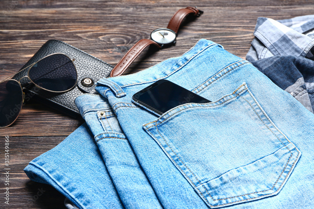 Set of male clothes and accessories on wooden background