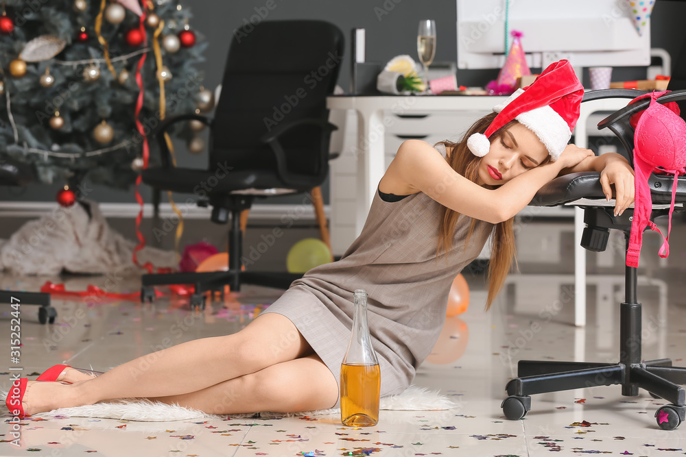 Young woman with hangover after New Year party in office