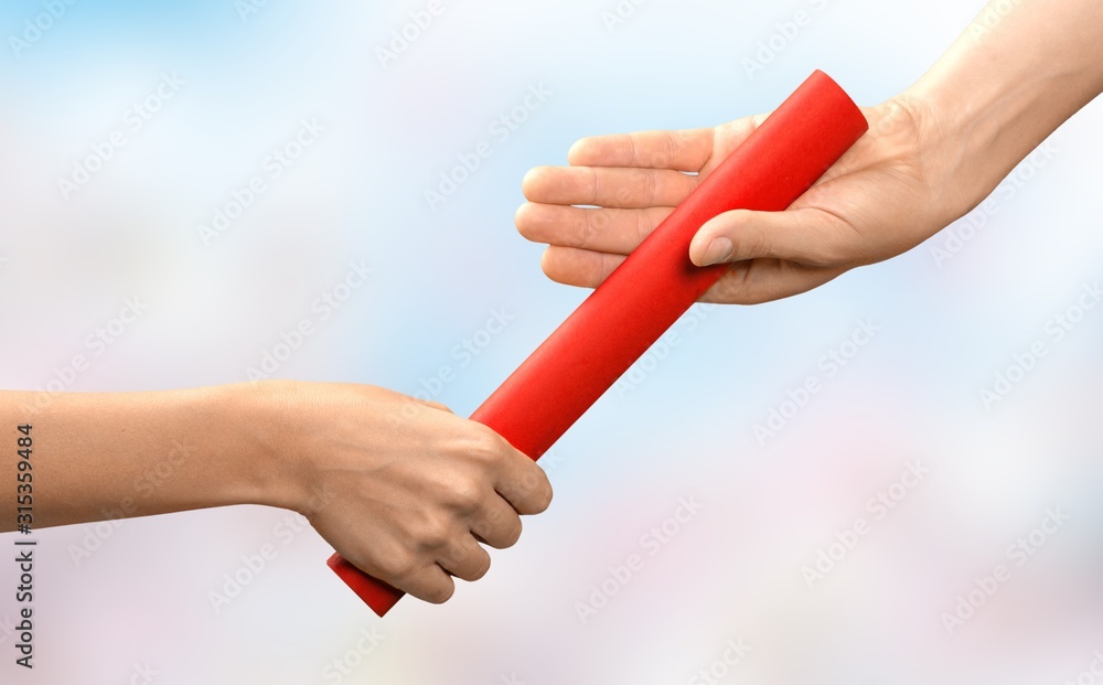 Close-up of relay baton being passed