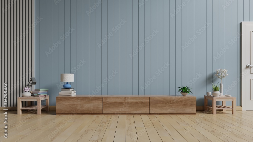 TV stand and wooden cabinet,blue wall.