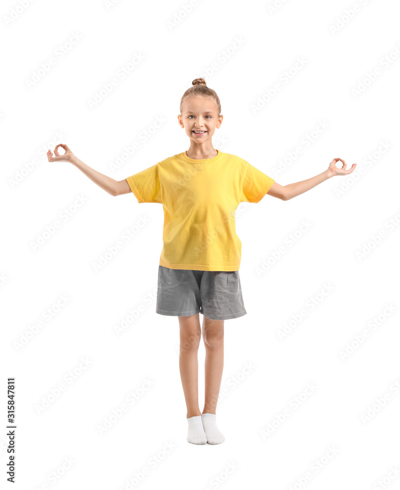 Little girl practicing yoga on white background