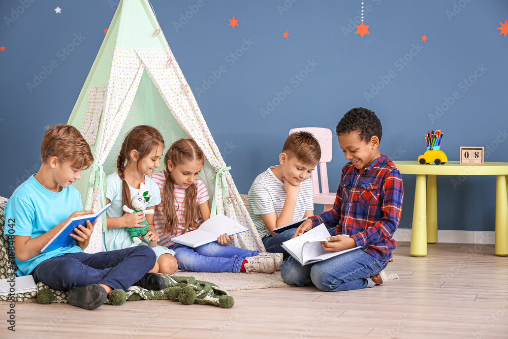 Cute little children reading books indoors