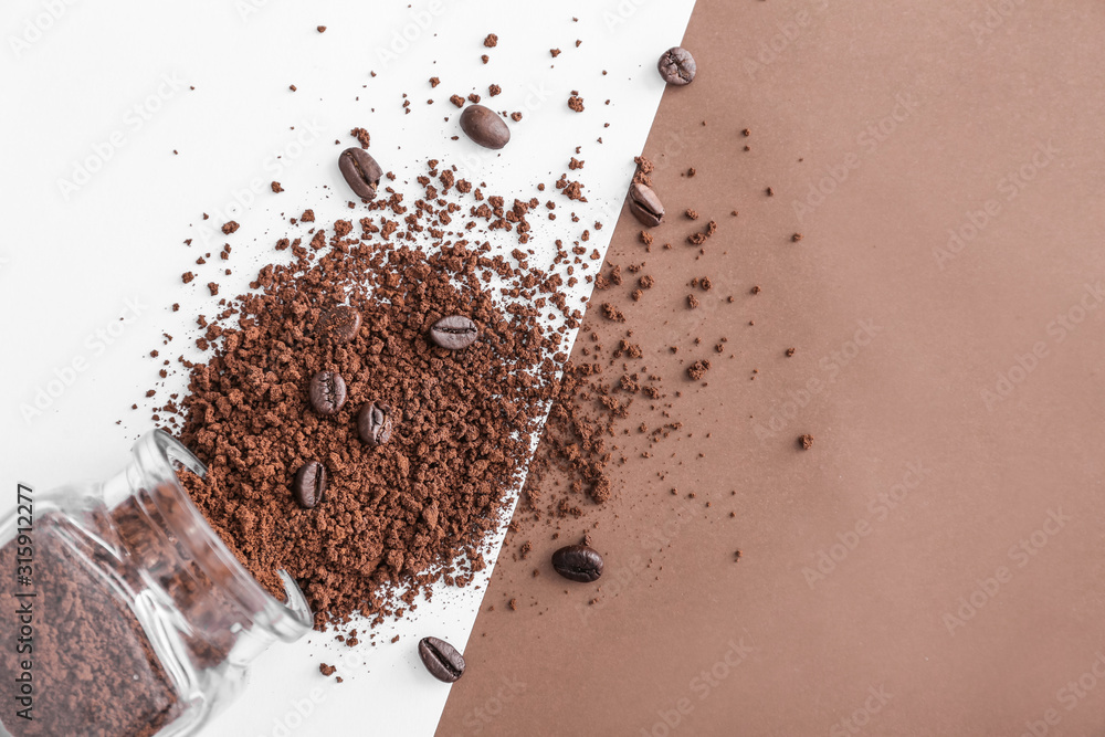 Jar with milled coffee beans on color background