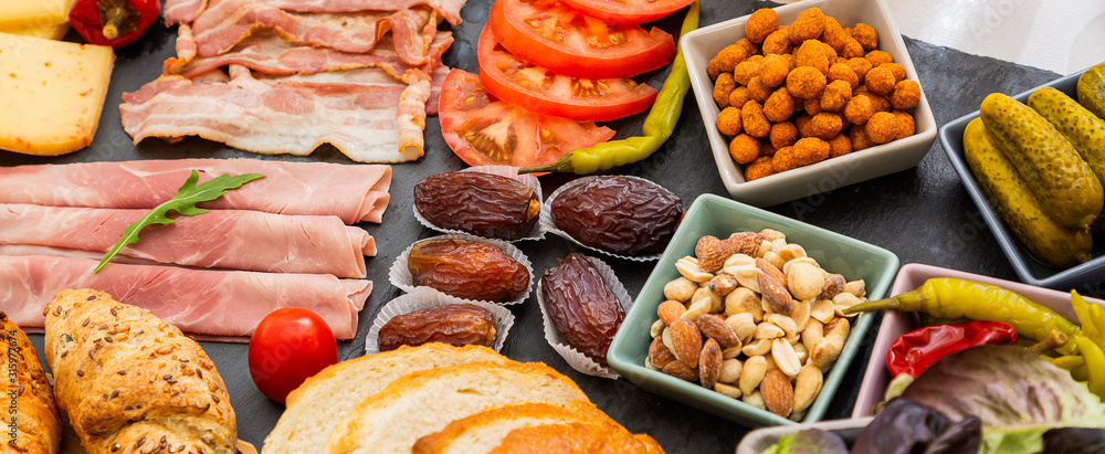 Breakfast on the table. Croissant bread, Croissant cereal, Bacon, ham, cheese, lettuce, beans, corn 