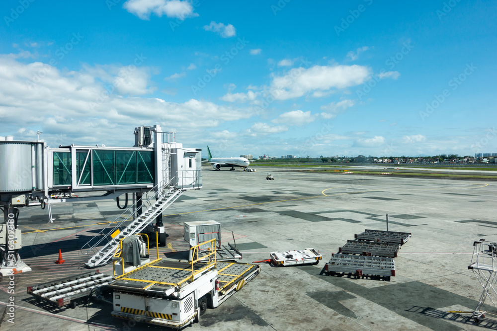 Manila Airport terminal in philippines outdoor view in daytime. Terminal connecting bridge to airpla