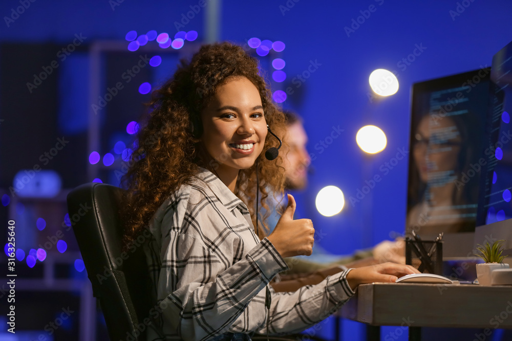 Technical support agents working in office at night