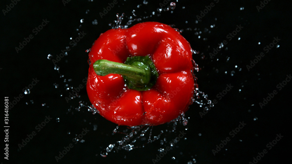 Freeze motion of rotating and flying red pepper