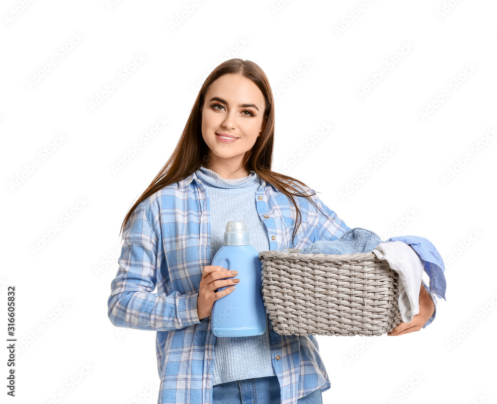 Beautiful young woman with laundry on white background