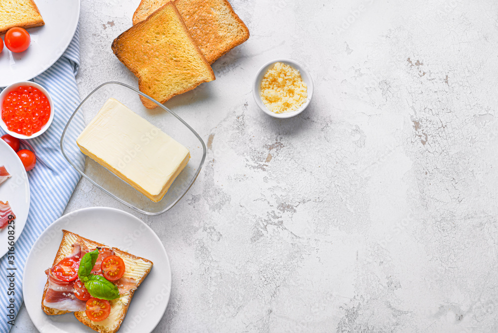 Fresh butter with tasty sandwich on white background