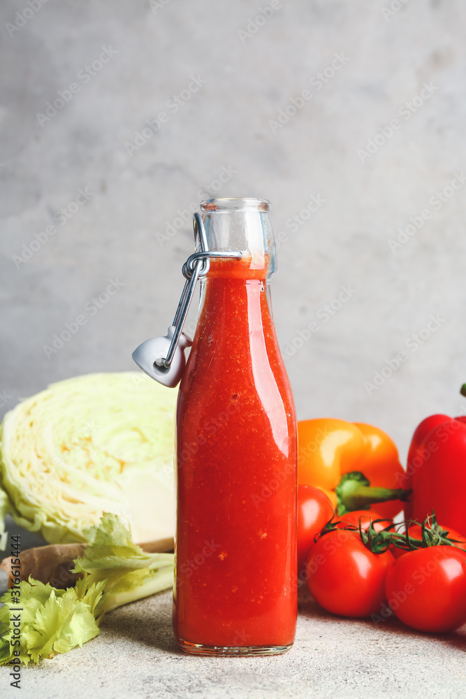 Bottle of fresh vegetable juice on table