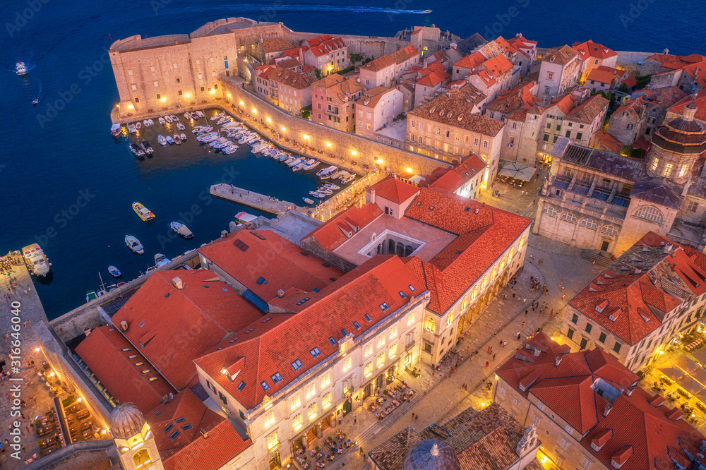 Aerial view of boats and yachts and beautiful architecture at night in Dubrovnik, Croatia. Top view 