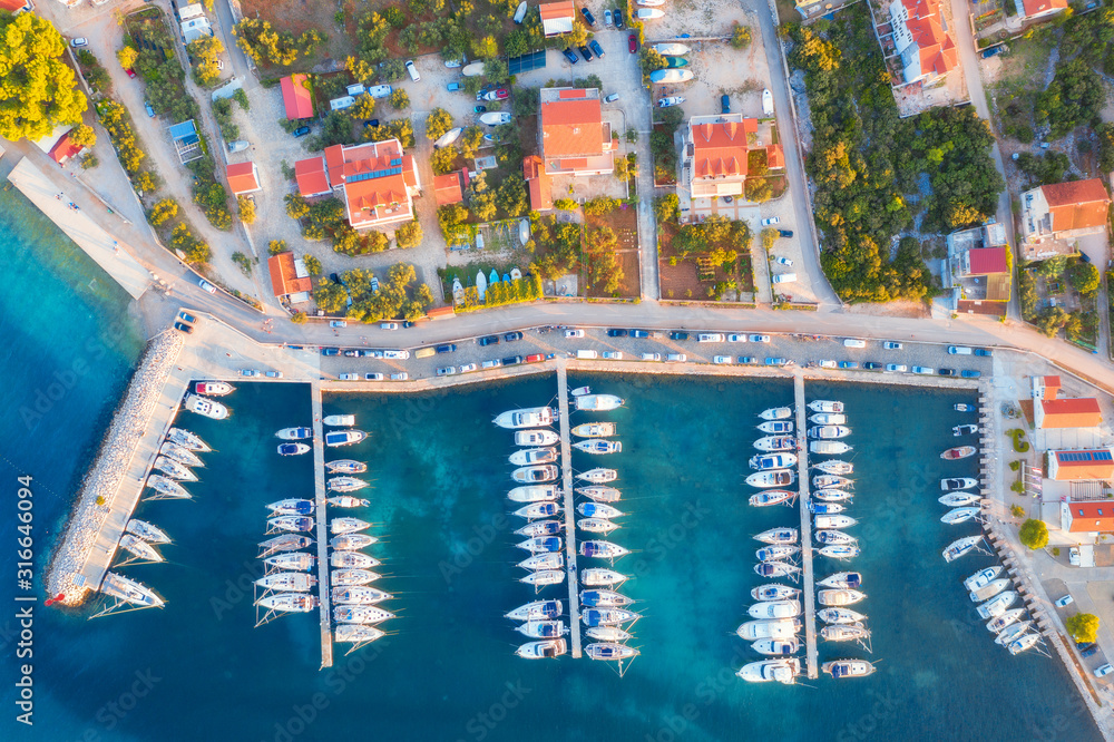 Aerial view of boats and yachts in port in old city at sunset. Summer landscape with houses with ora