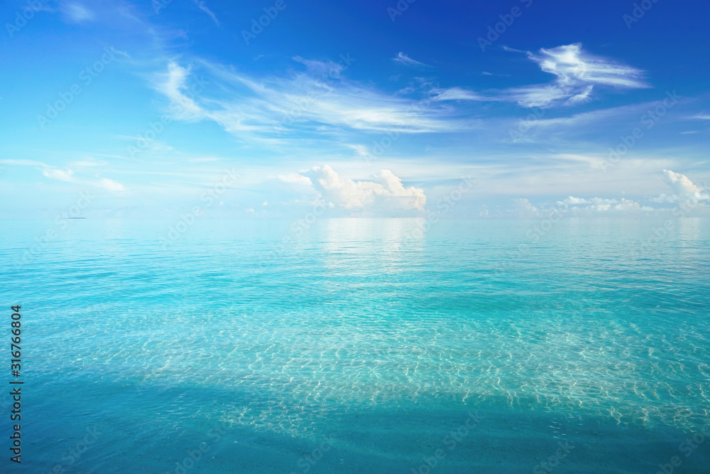 Beautiful white cloud in blue sky over turquoise water ocean, Maldives.