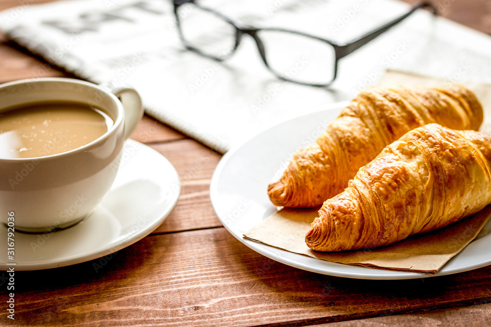 Businessman morning cup of coffee at home with newspaper