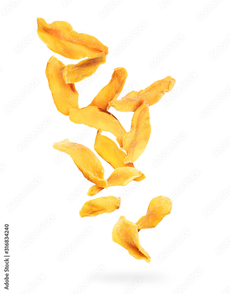 Dried chopped mango slices falling down on a white background