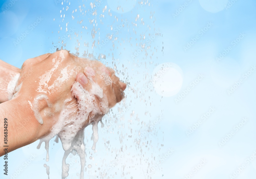 Man washing hands in clean water on blue background