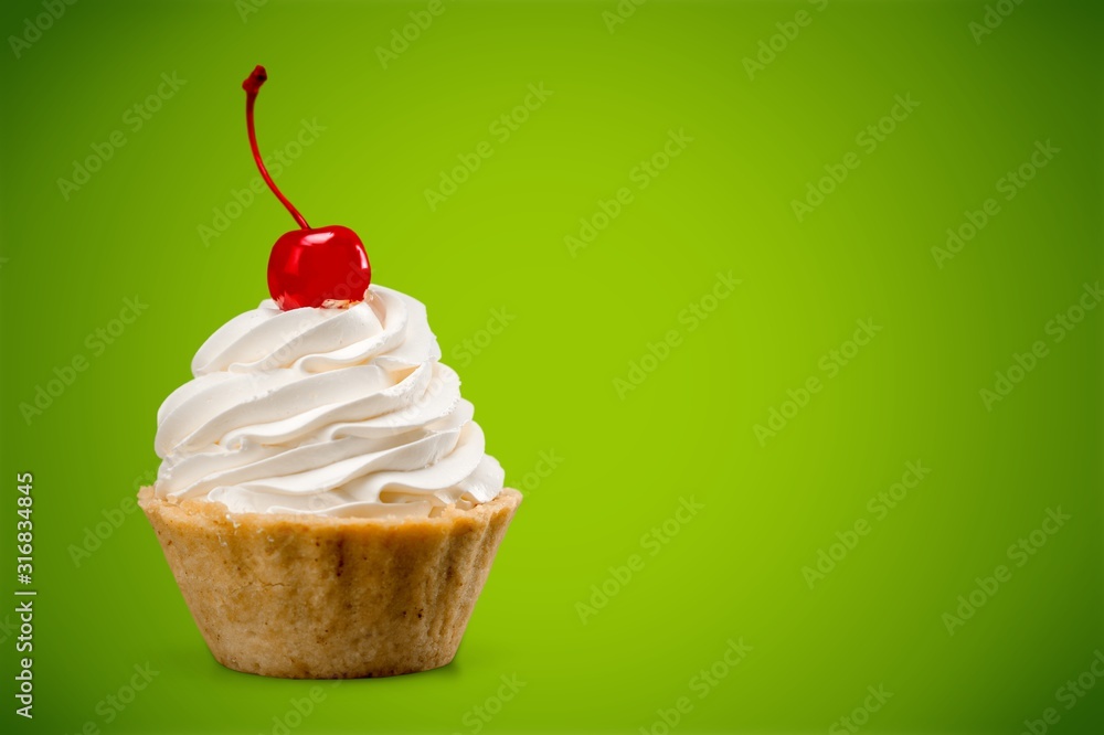 Cupcake with whipped cream and cherry