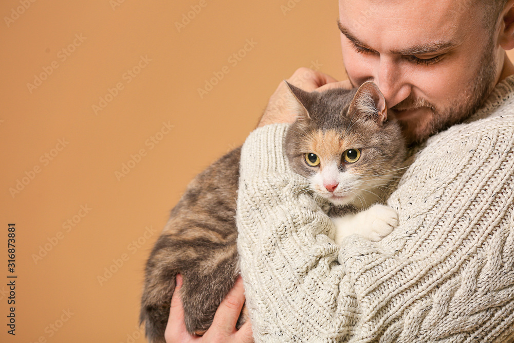 Man with cute cat on color background