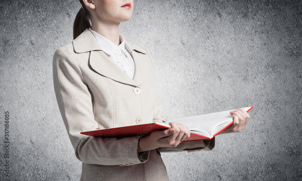 Corporate employee holding open notebook