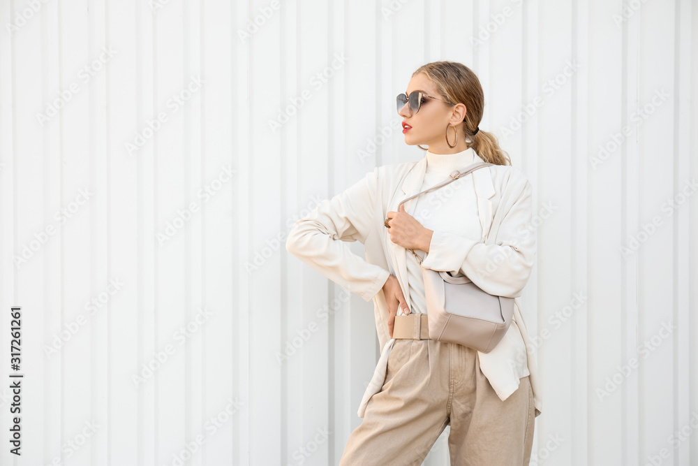 Portrait of fashionable young woman on white background