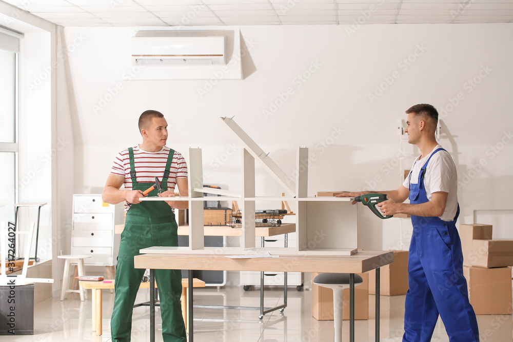 Handymen assembling furniture in workshop