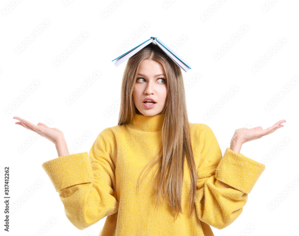 Beautiful young woman with book on white background