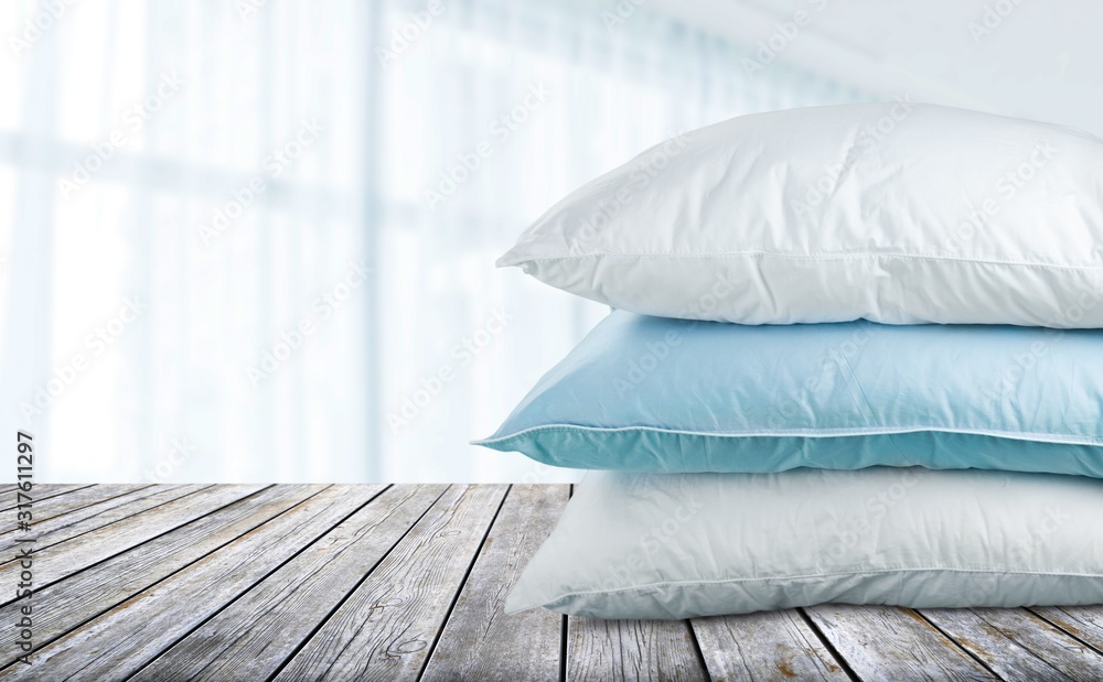 Soft Pillows Pile on bokeh background, three pillow, sleeping items.