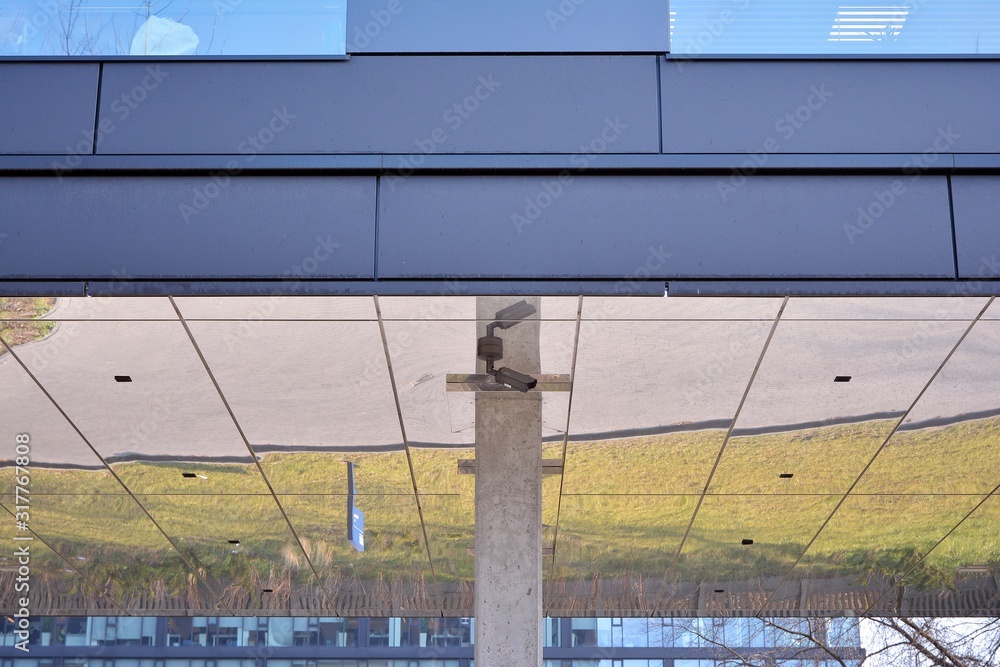 A view at a straight facade of a modern building with a dark grey facade.