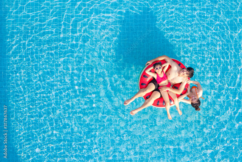 Asian family relax in swimming pool